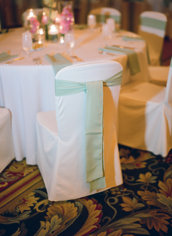 light green cloth ties on chair backs - sweet southern military style wedding photo by Charleston wedding photographer Virgil Bunao